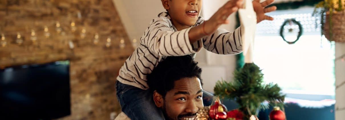 Airbnb Holiday Pricing - father with his son decorating