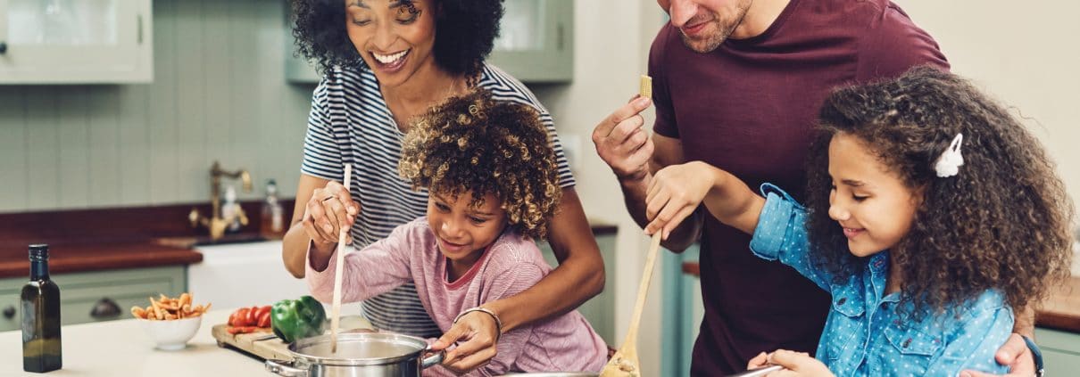 A family cooking inside of a short term rental