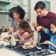 A family cooking inside of a short term rental