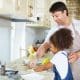 Father daughter cleaning dishes in Airbnb